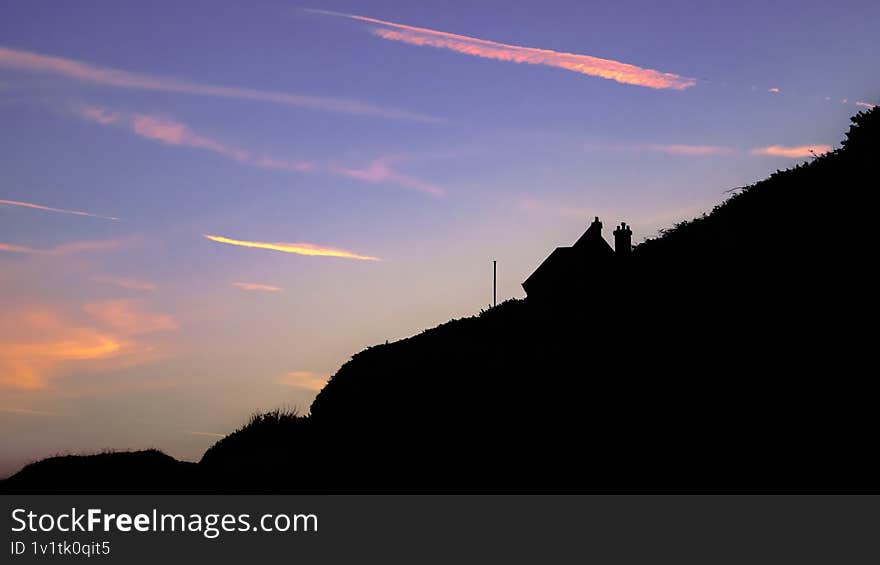Dark silhouette of the house in Etretat during the sunrise