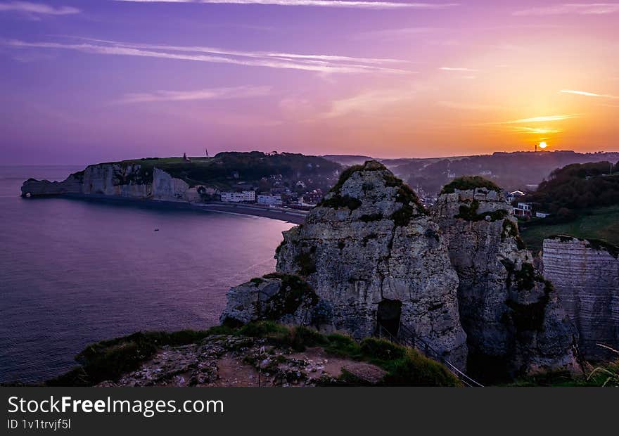 Purple sunrise over the cliffs in Etretat