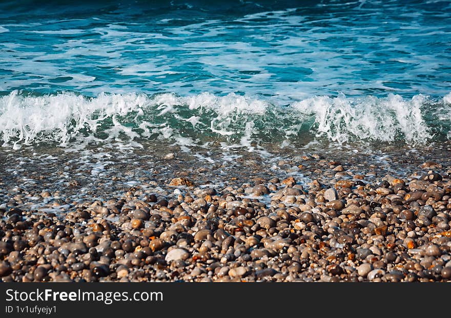 white waves at the pebble beach, layered compostition