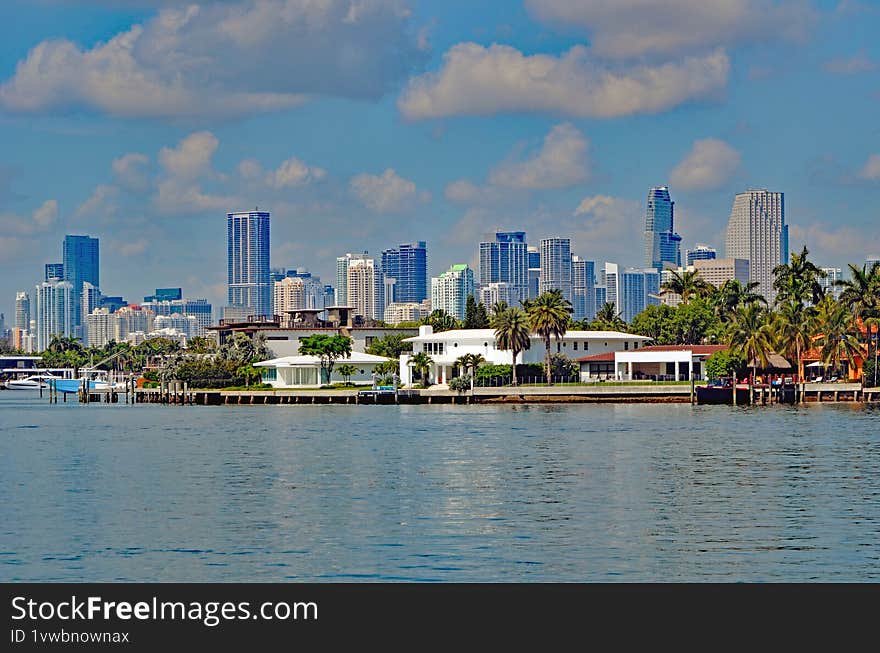 Luxury Island Homes in Miami Beachagainst a background of the downtown Miami tall building skyline