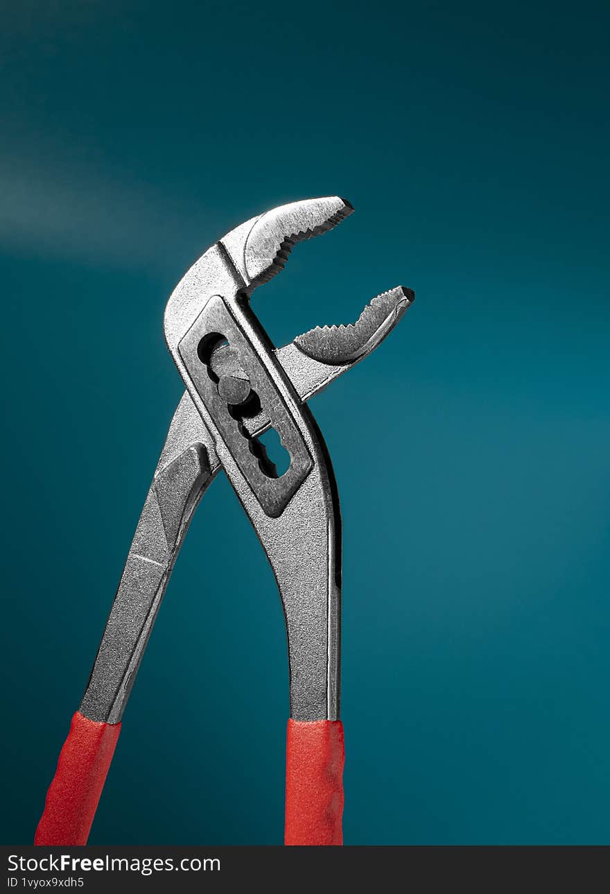 pliers, a tool, stands on a blue background