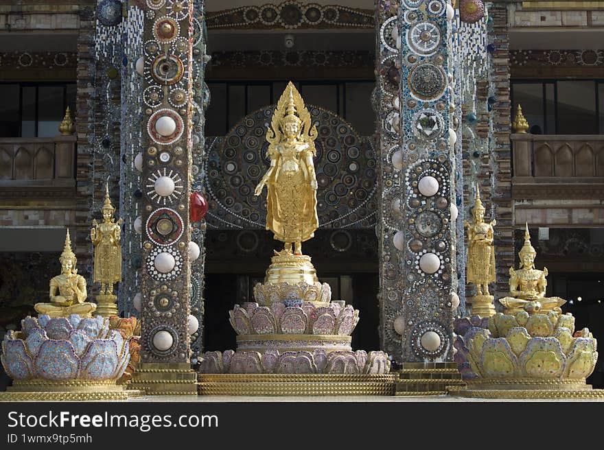 golden buddha statues in front of shrine
