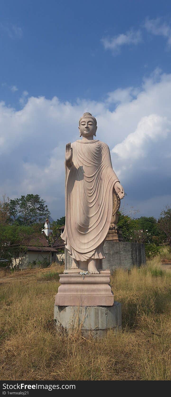 old stone sculpture Buddha standing statue