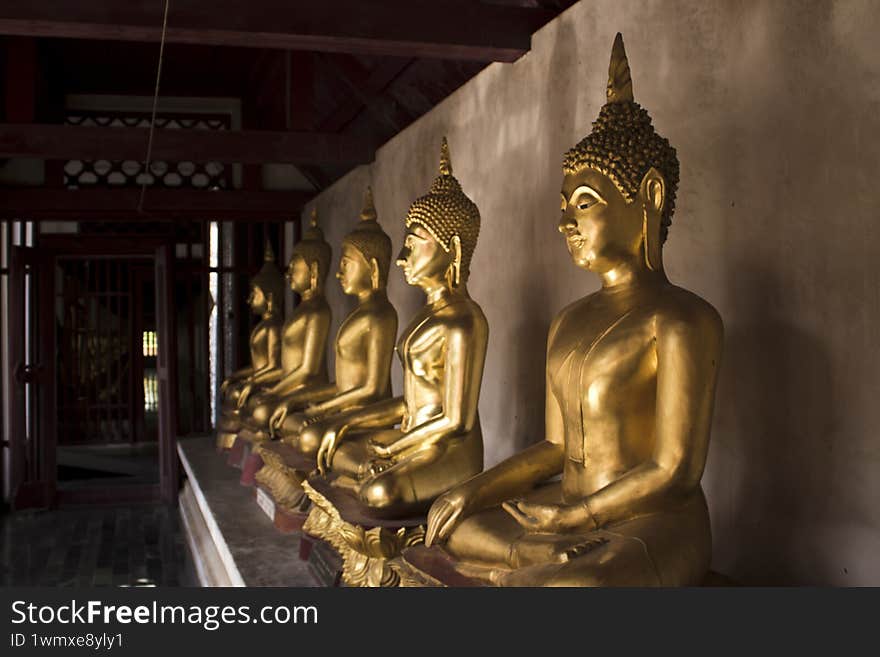 Gold buddha statues in temple Phitsanulok Thailand
