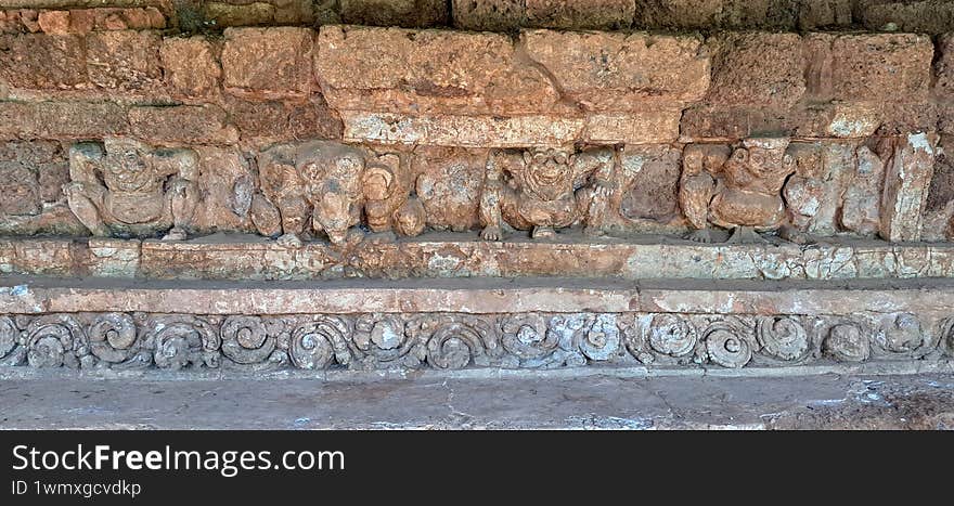 mythology statues on the stone wall in southeast Asia archaeological site