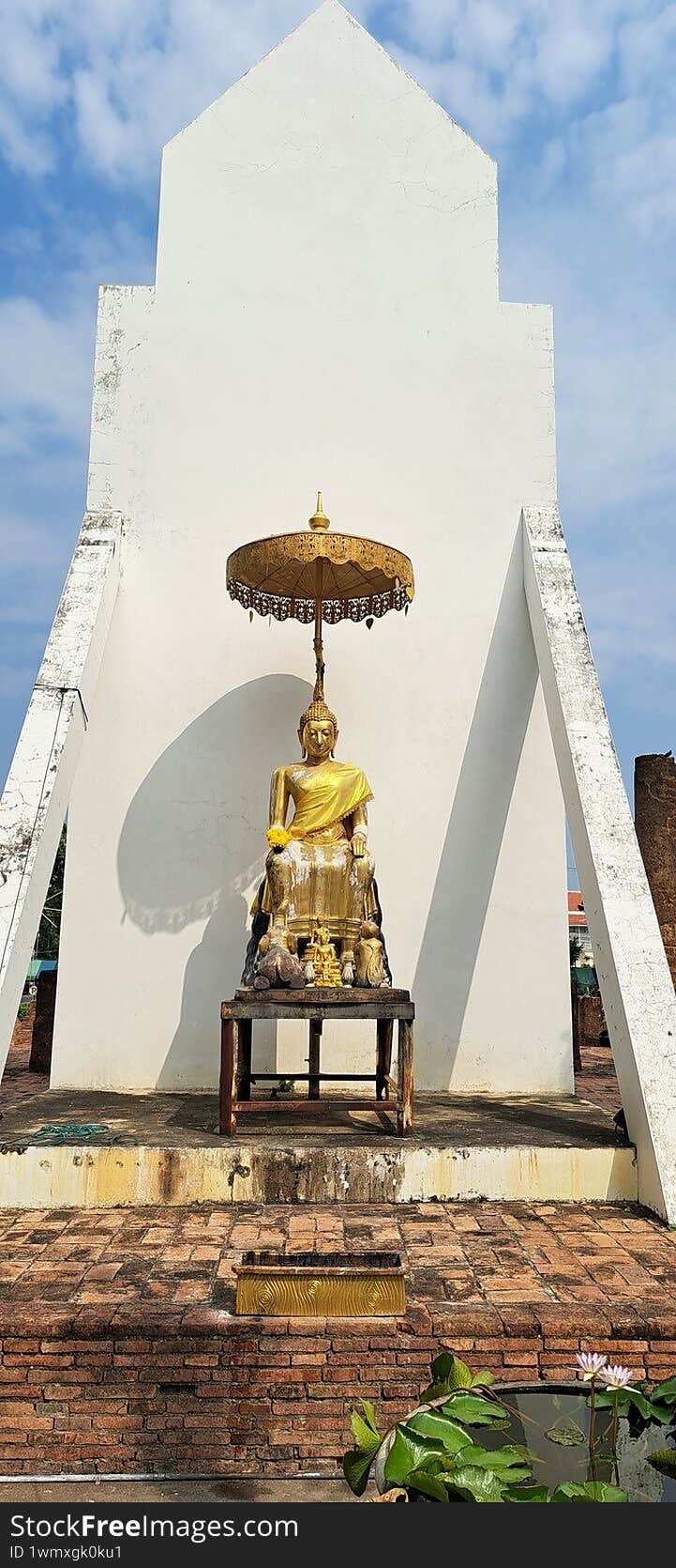 sitting Golden Buddha statue in Temple Phitsanulok Thailand