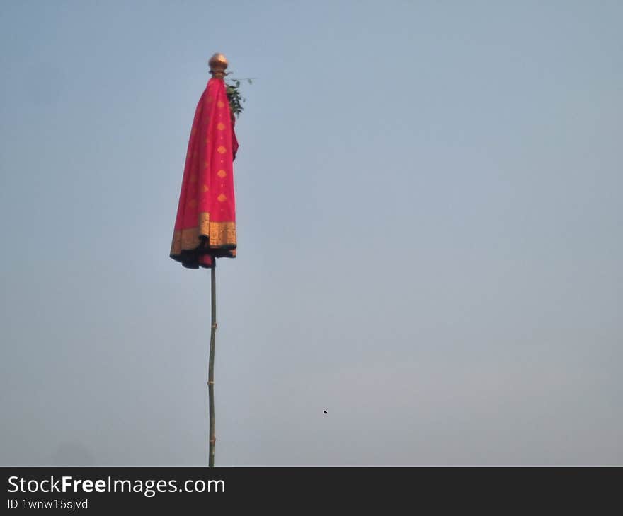 a Gudi, a traditional flag-like symbol hoisted during the Gudi Padwa festival, which marks the traditional New Year for Marathi and Konkani Hindus. a Gudi, a traditional flag-like symbol hoisted during the Gudi Padwa festival, which marks the traditional New Year for Marathi and Konkani Hindus.