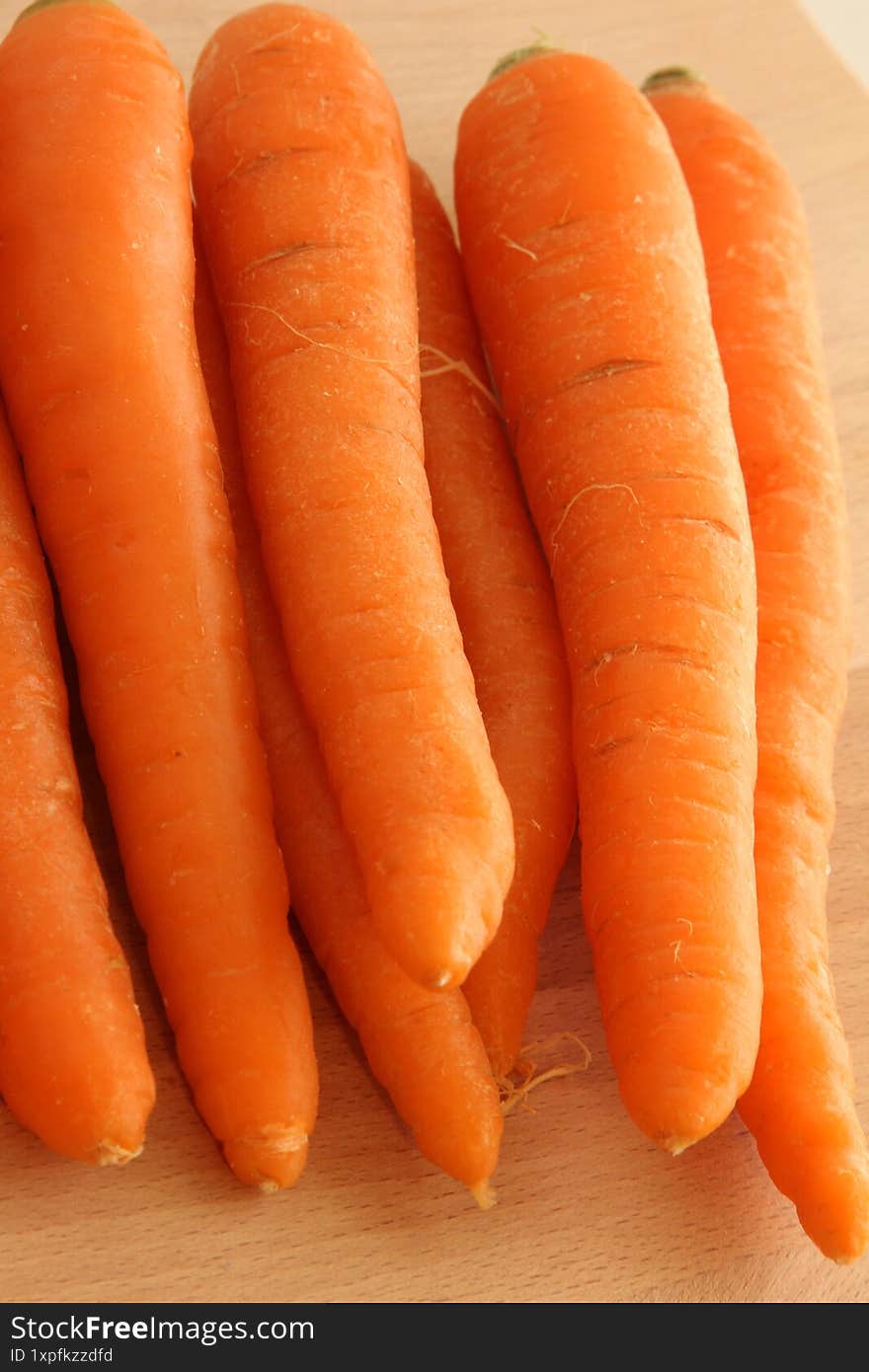 Carrots on wooden background.