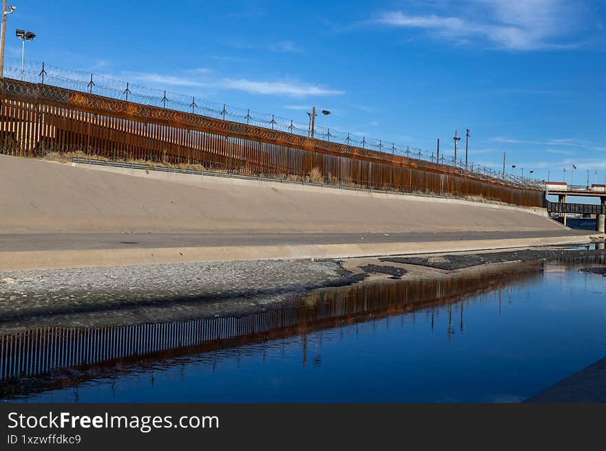 Border barrier in Ciudad Juarez, where migrants face the Rio Grande s concrete channel and barbed wire