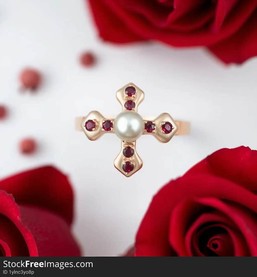 Pearl and Ruby cross ring on roses background AI generated.