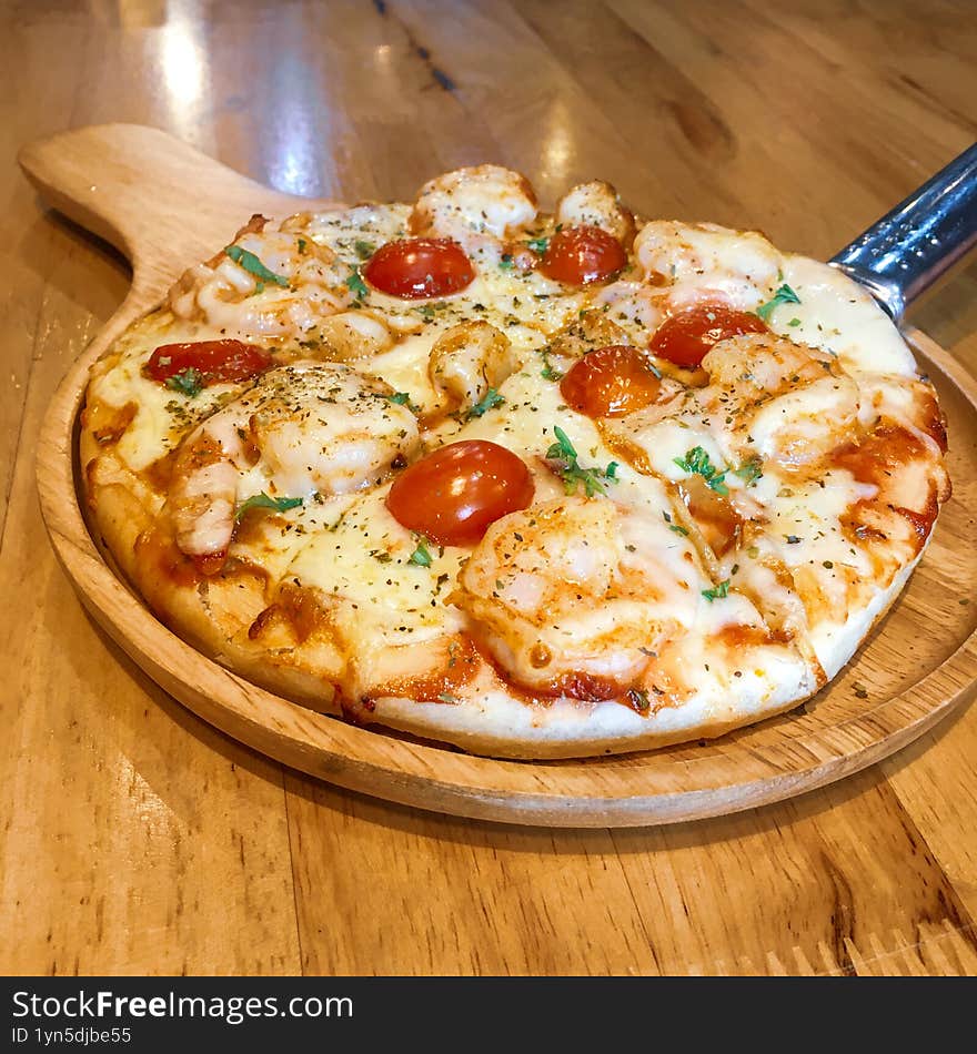 Shrimp and Cherry Tomato Pizza on a Wooden Board