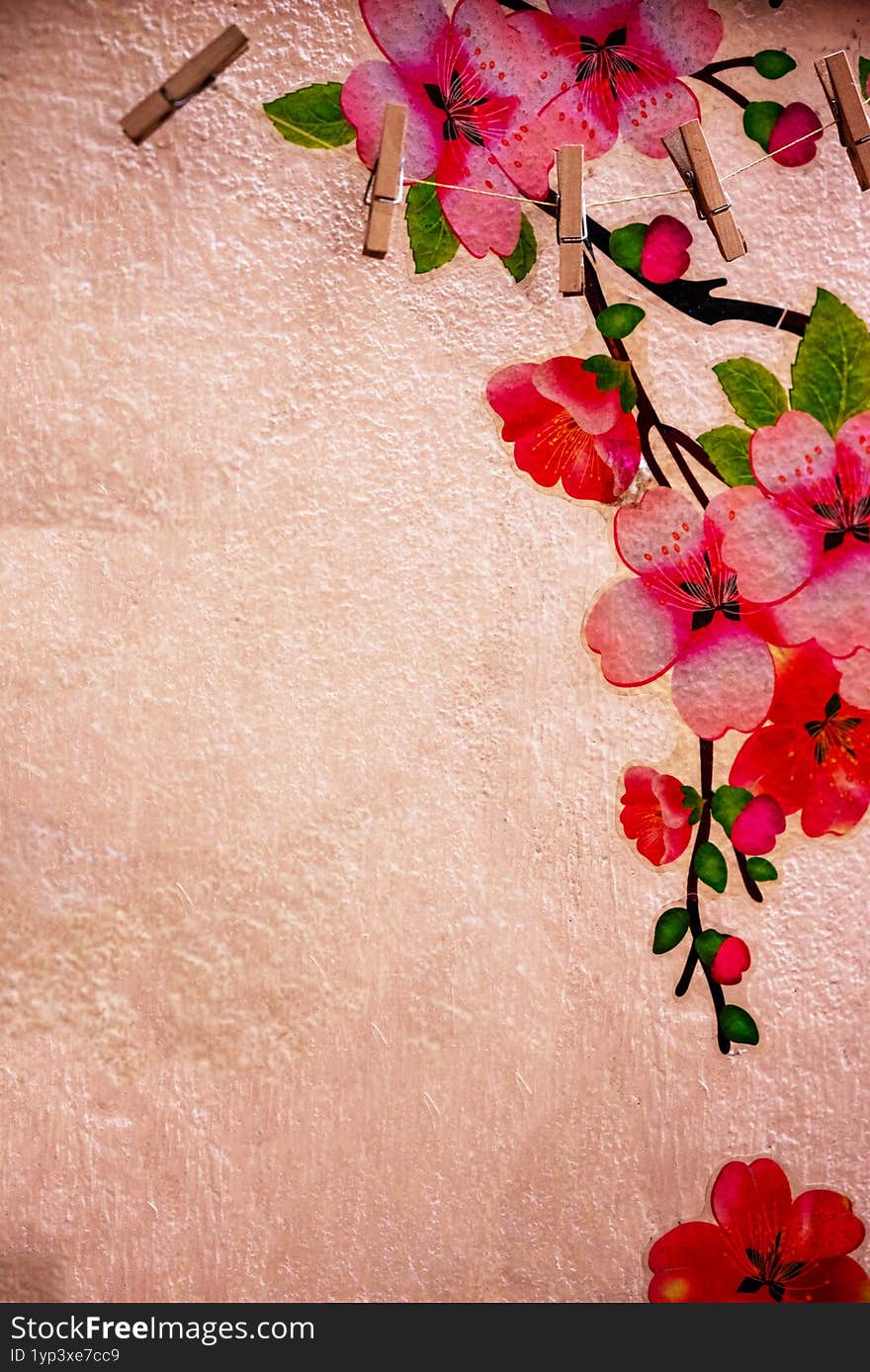 A vibrant arrangement featuring cherry blossom art with neatly placed clothespins against a textured background, blending nature-i