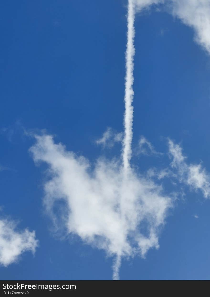 Zoom shot of an airplane trail overhead. Zoom shot of an airplane trail overhead