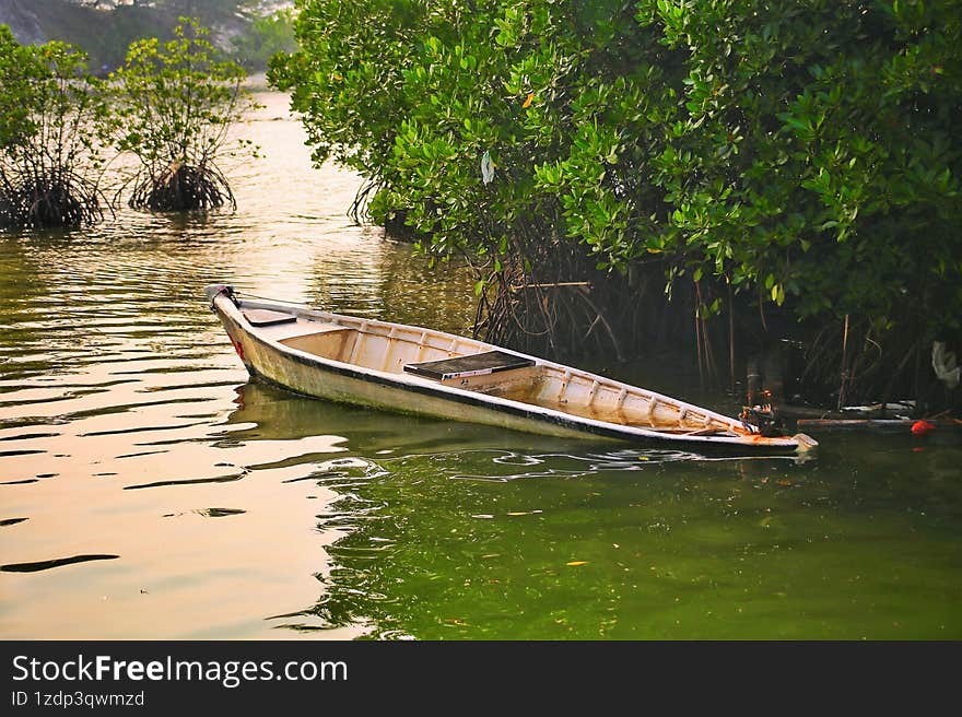 A small leaking boat is about to sink by the mangroves in Pramuka Island of the Thousand Island Regency