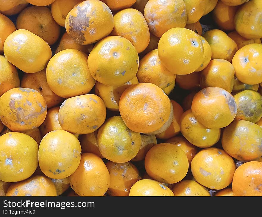 fresh orange fruits with leaves as background top view