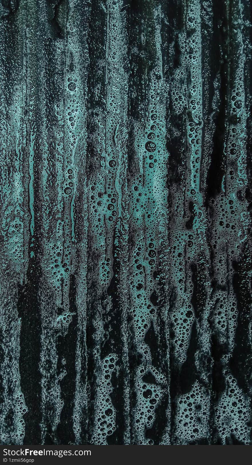 Cyan-colored laundry detergent on a laundry board, close-up shot, abstract background.