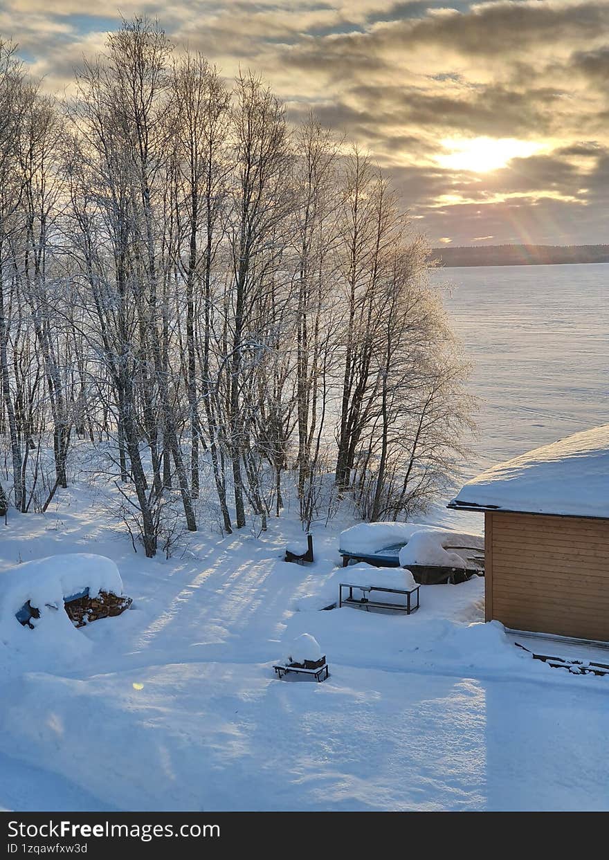 A house on the shore of a northern, frozen lake