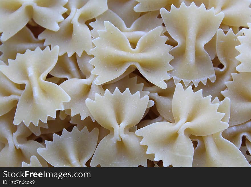 A close-up photo of uncooked farfalle pasta