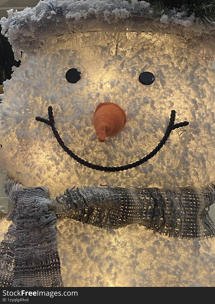 smiling snowman with scarf during christmas