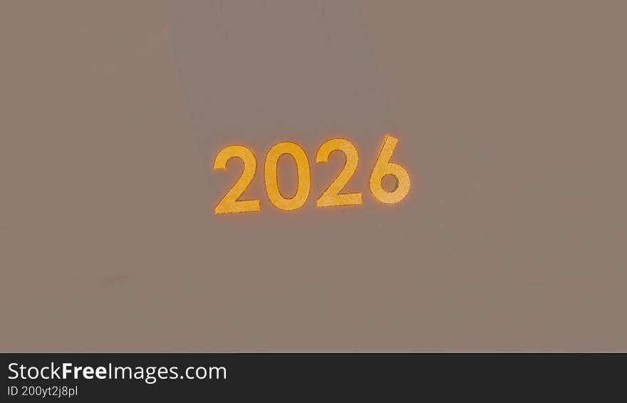 The image displays the number 2026 in a bold, yellow font against a grey background.