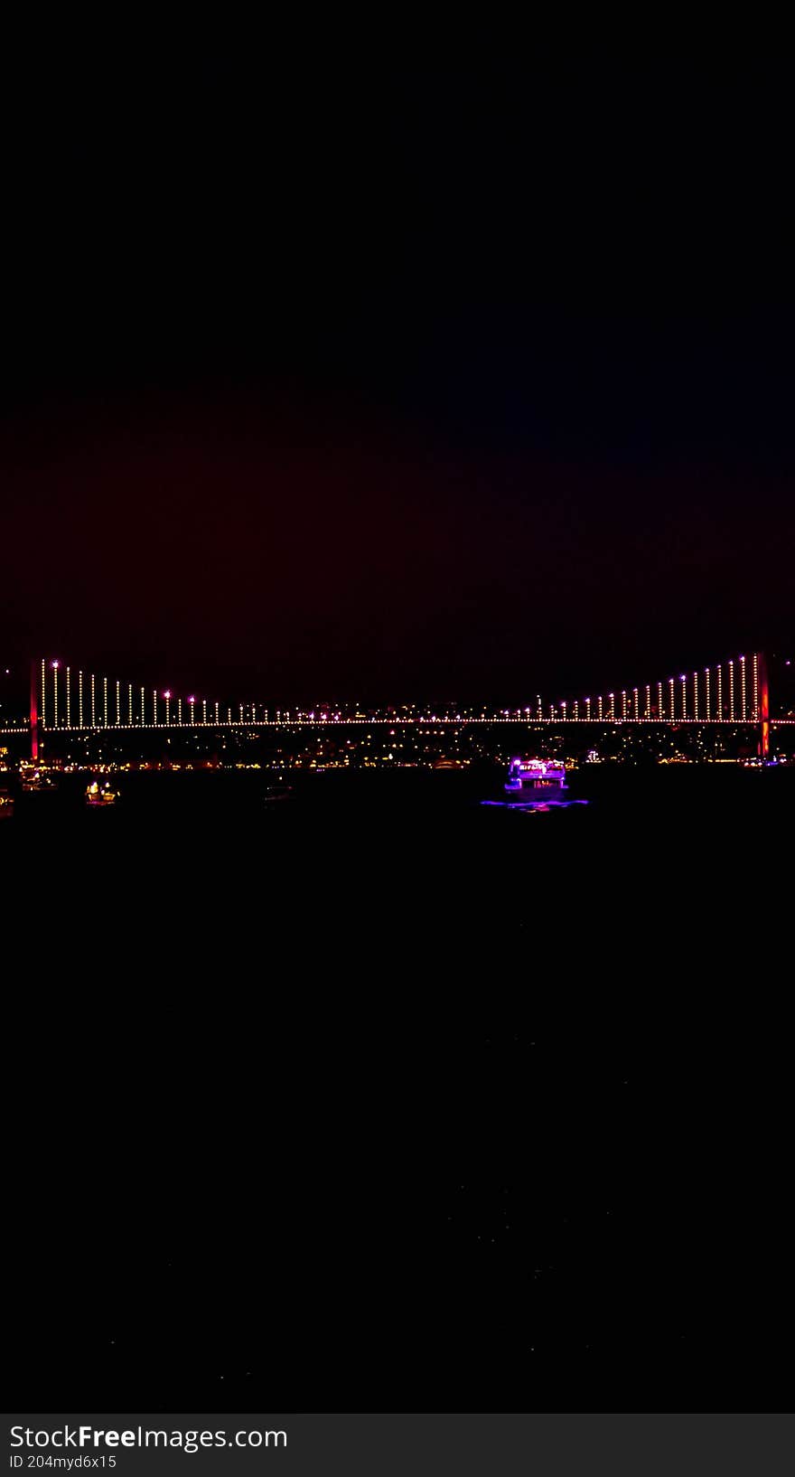 Majestic Bosphorus Bridge illuminated at night, stretching across the strait between Europe and Asia. Stunning city landmark and symbol of unity. Majestic Bosphorus Bridge illuminated at night, stretching across the strait between Europe and Asia. Stunning city landmark and symbol of unity.