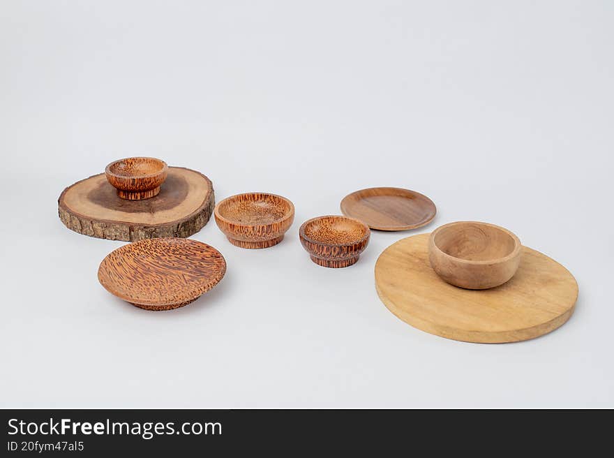 Set of wooden bowls and plates on white background