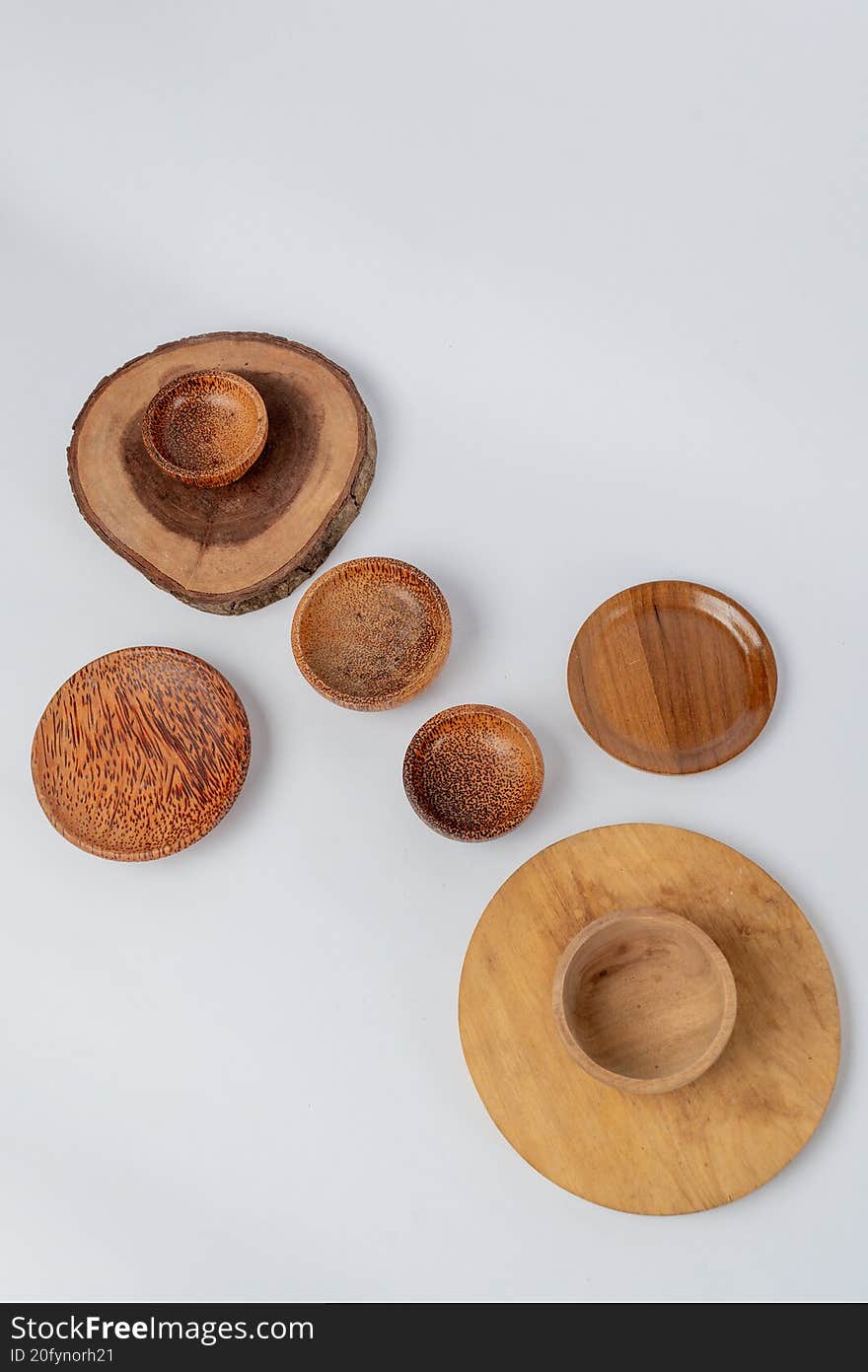 Top view wooden plates and bowls on white