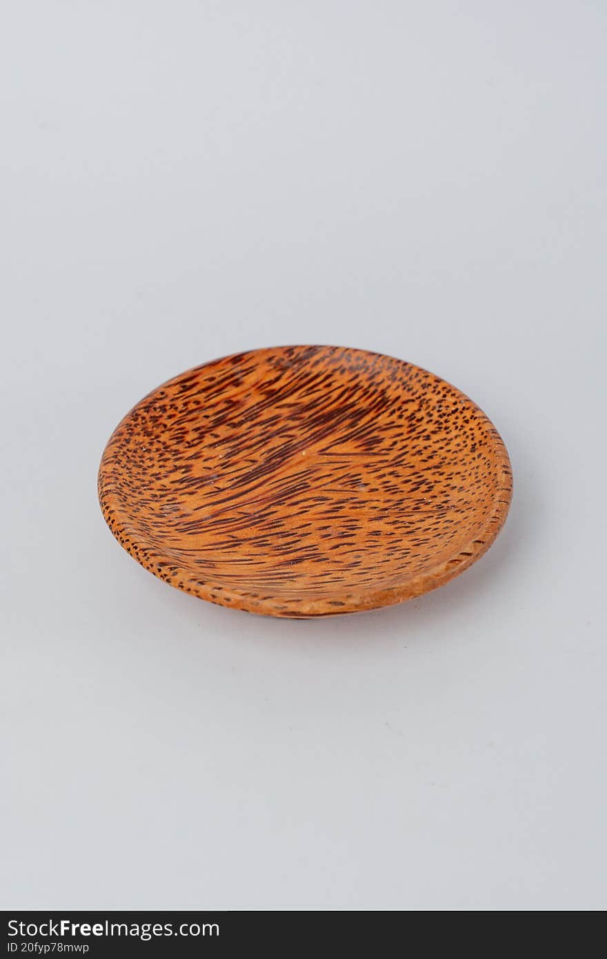 Top view small textured wooden plate on white