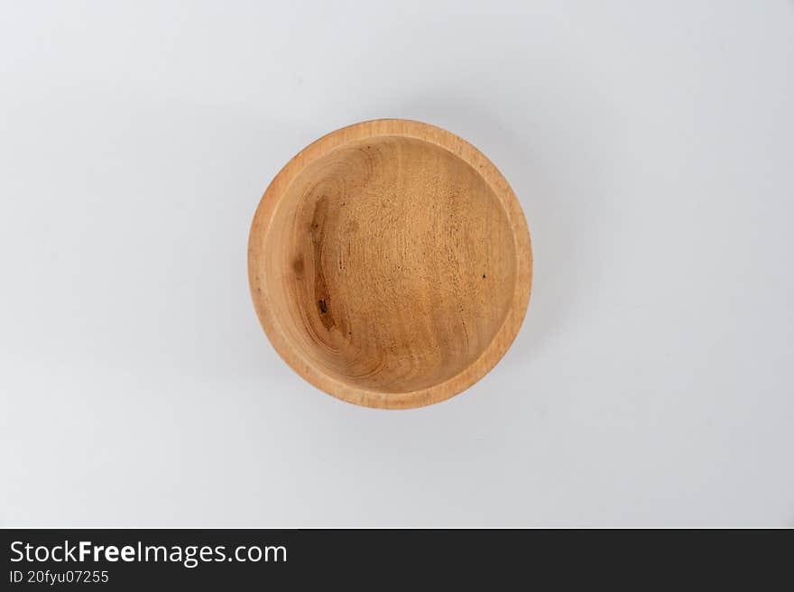Top view empty round wooden bowl on white background