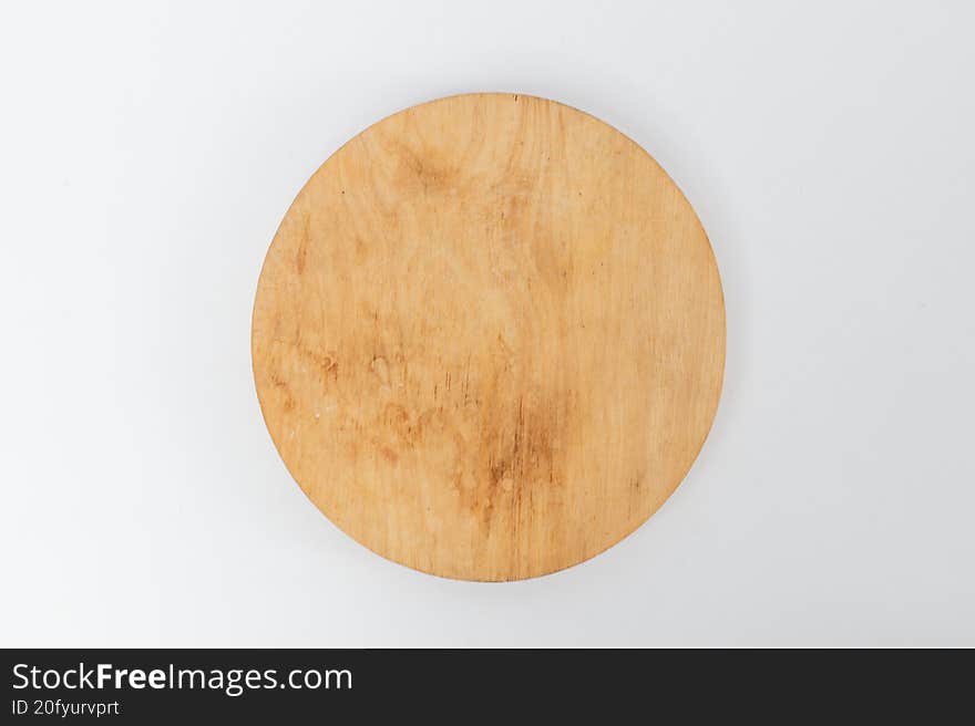 Top view round wooden board on white background