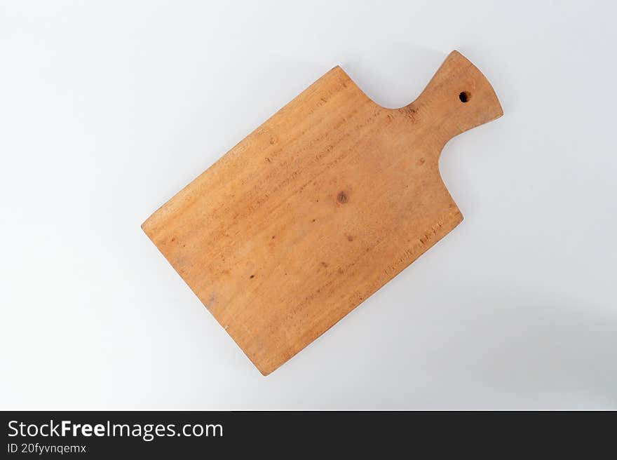 Top view wooden cutting board on white