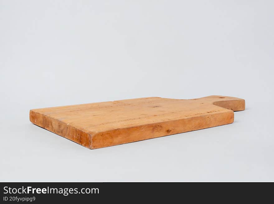 Side view wooden cutting board on white