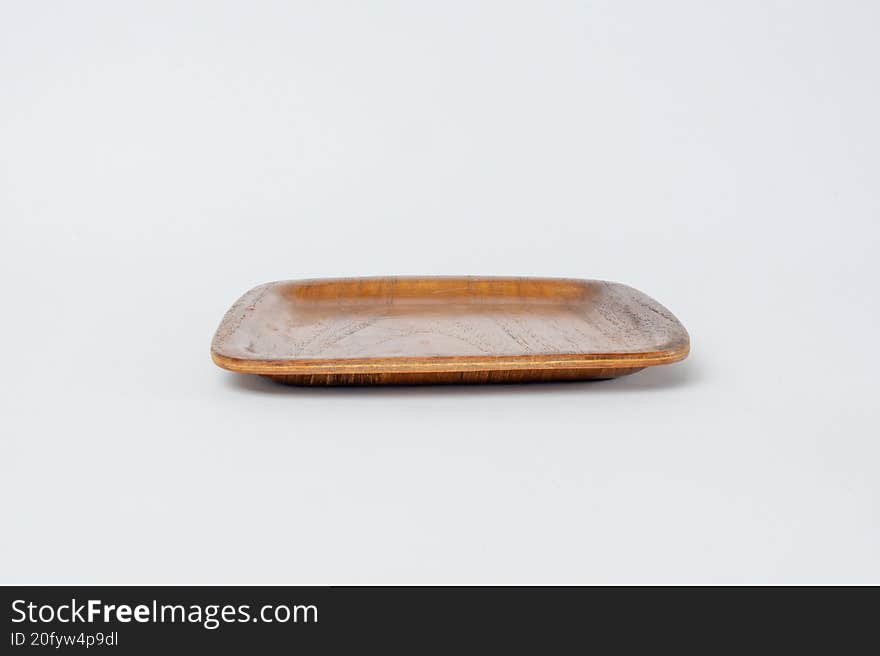 Side view wooden plate on white background