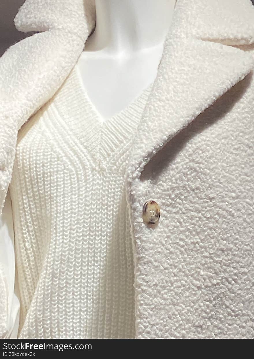 women's dress on mannequin with sweater and jacket