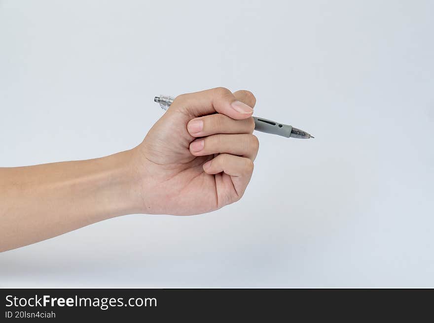 Hand holding silver pen on white background