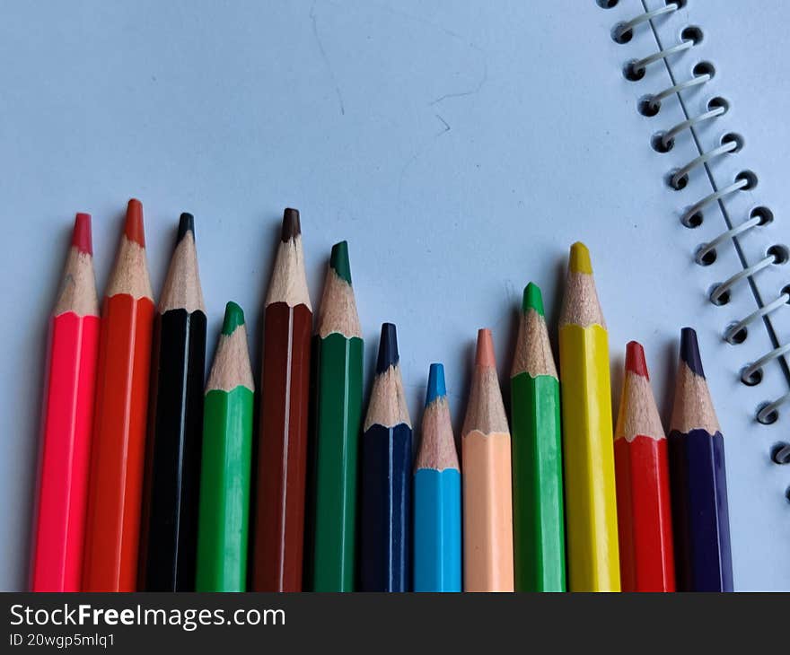 Colourful Pencil On Note Pad.