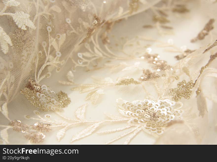 Close-up Of Delicate Light Pink Tulle Fabric With Handmade Floral Embroidery And Tiny Sequins. Elegant Bridal Textile With Soft Te