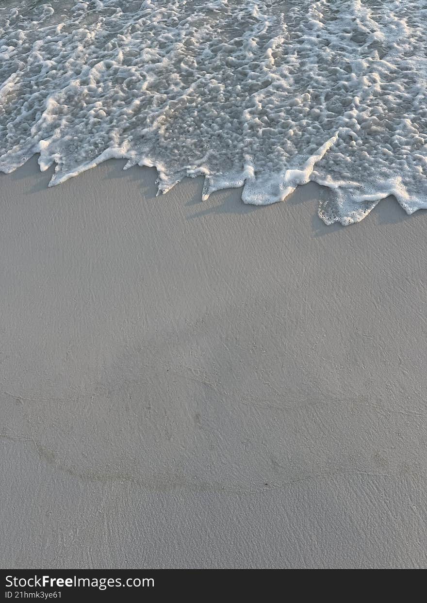 Background of beach foam and sand with copy space