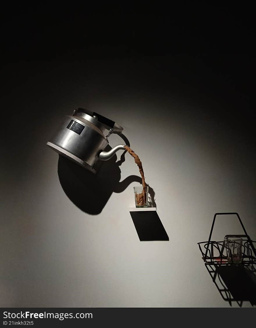 optical illusion of a magical teapot serving tea in a cup mid-air