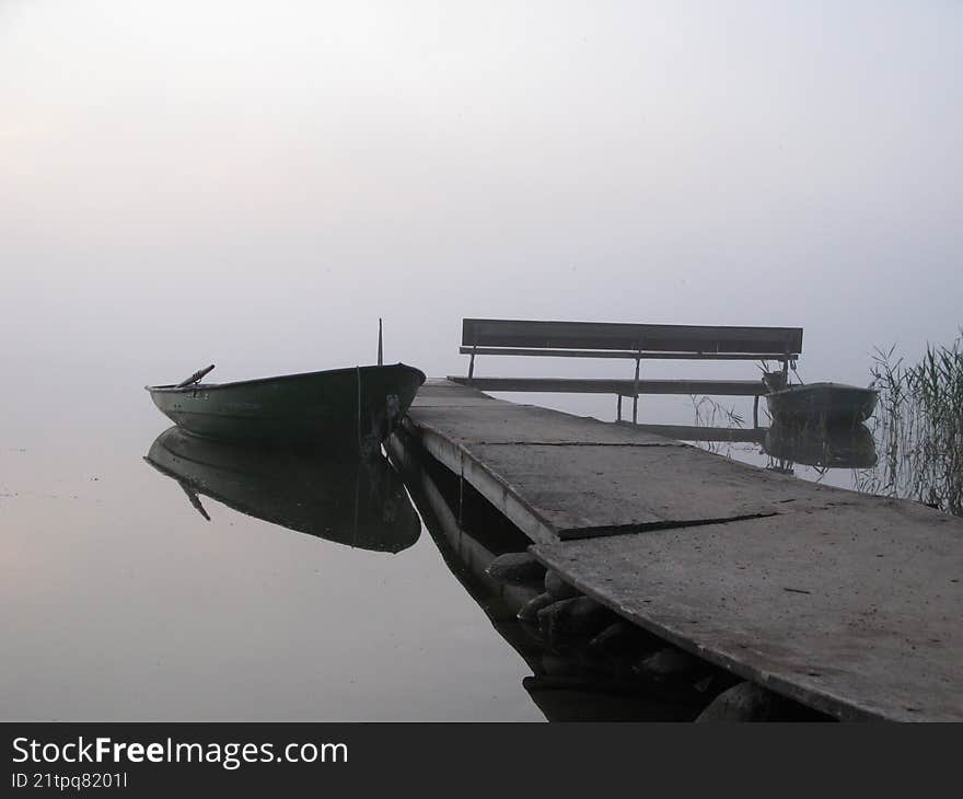 Misty morning with boats and dock