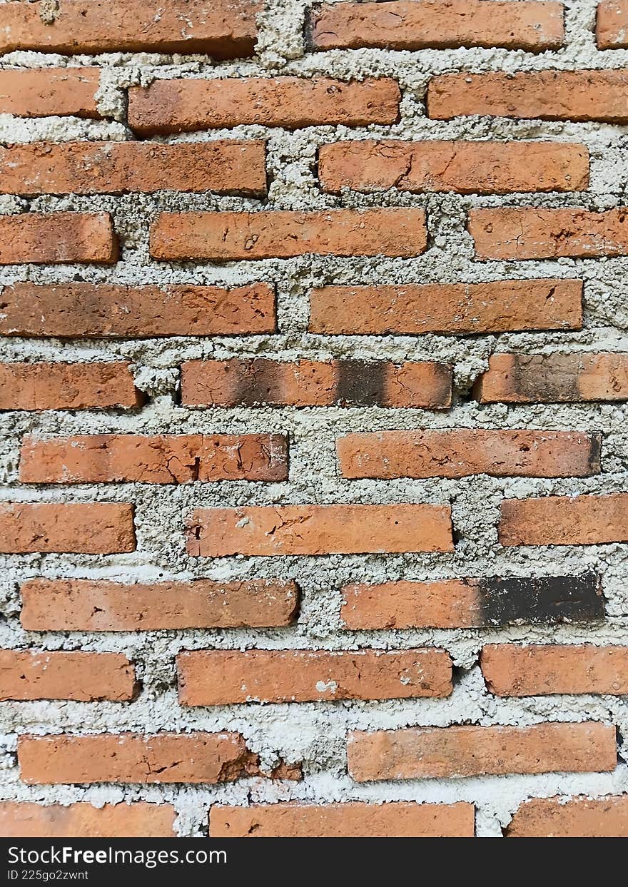 A very simple red brick wall with a slightly uneven arrangement. A very simple red brick wall with a slightly uneven arrangement.