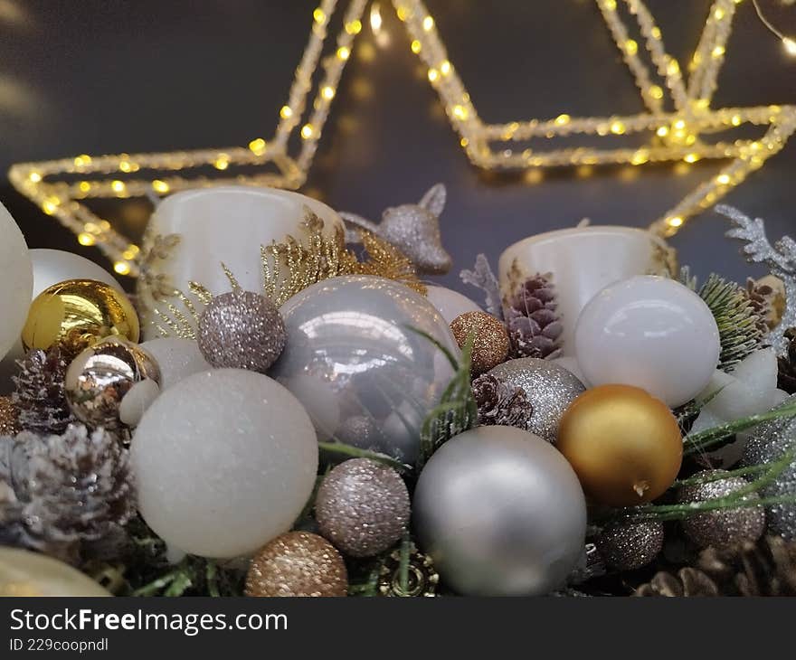 Christmas card, shiny, silver, white, with gold glittery baubles, with a golden star in the background.
