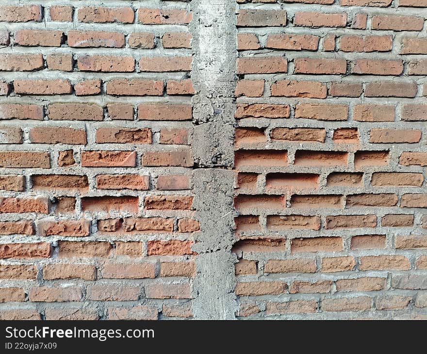 Rustic Red Brick Wall with Rough Grey Mortar and Vertical Concrete Column