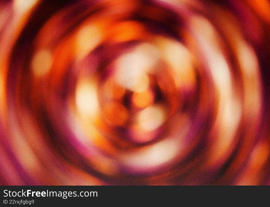 Vibrant psychedelic radial motion blur creates unique abstract background. Red abstract vortex texture with circular design and gr