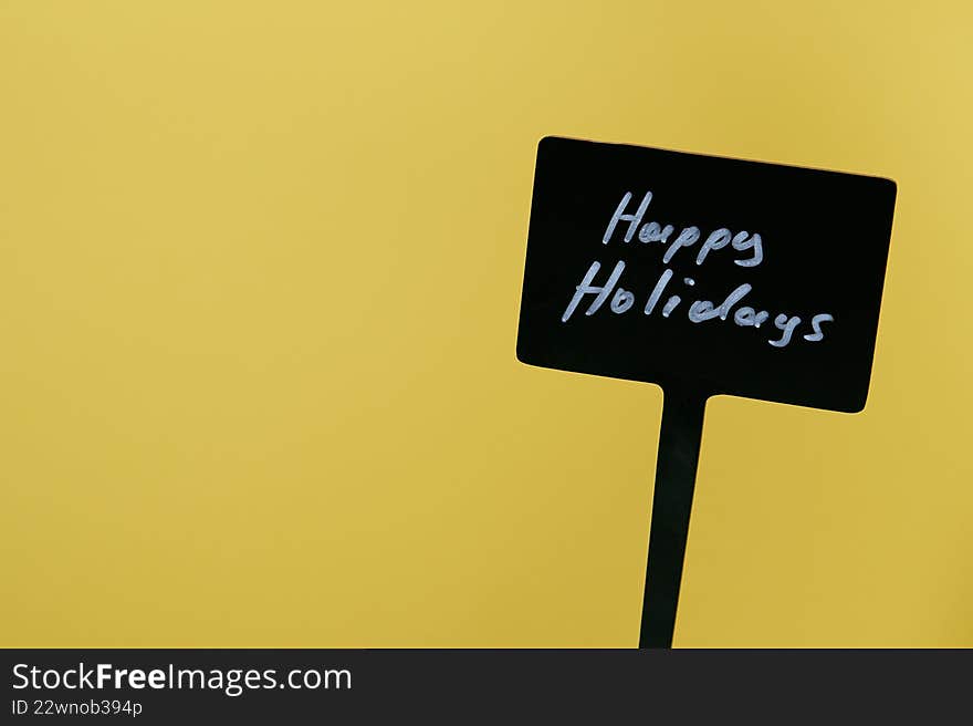 Happy Holidays sign in yellow background