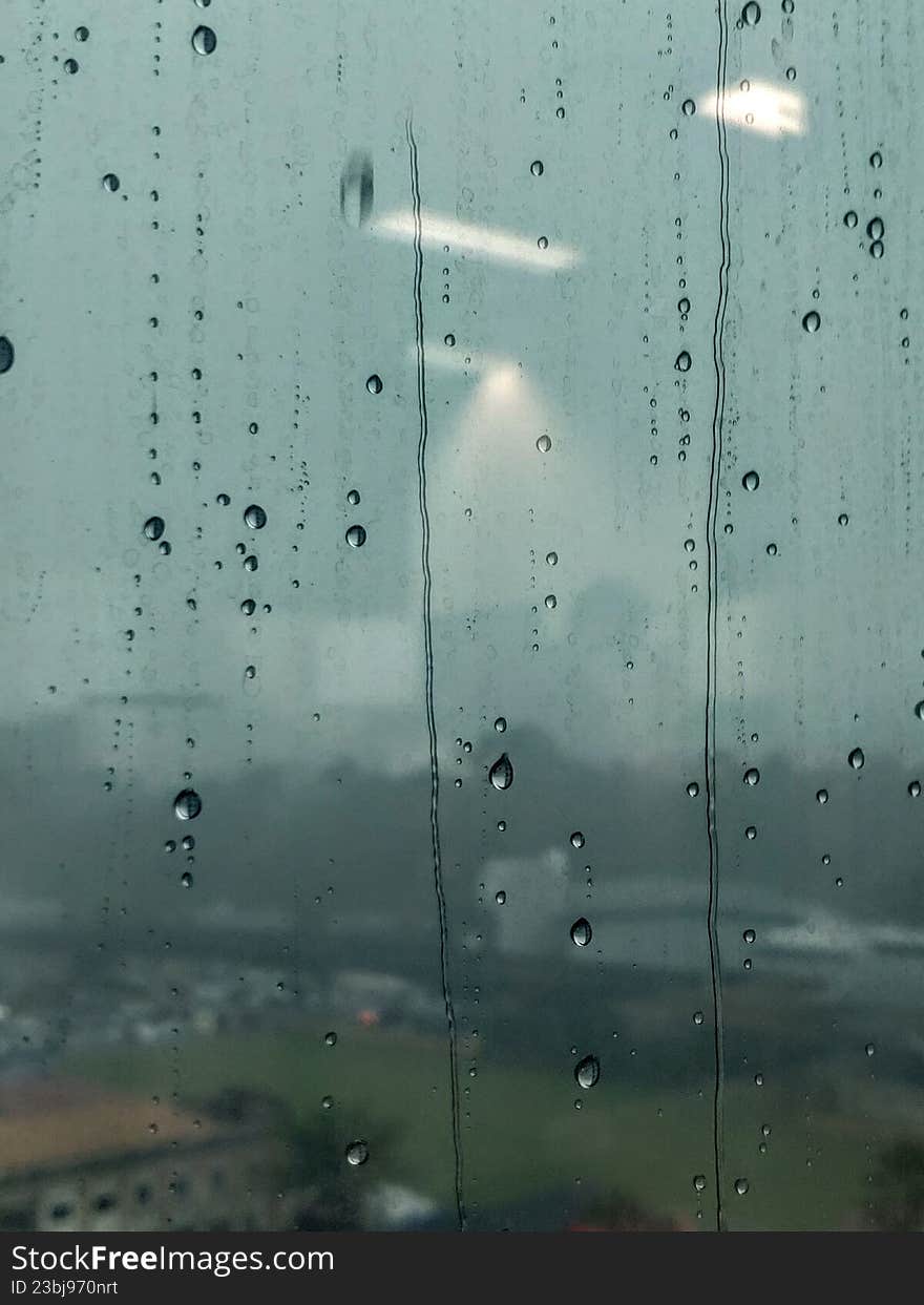Raindrops sticking to the window pane of a building
