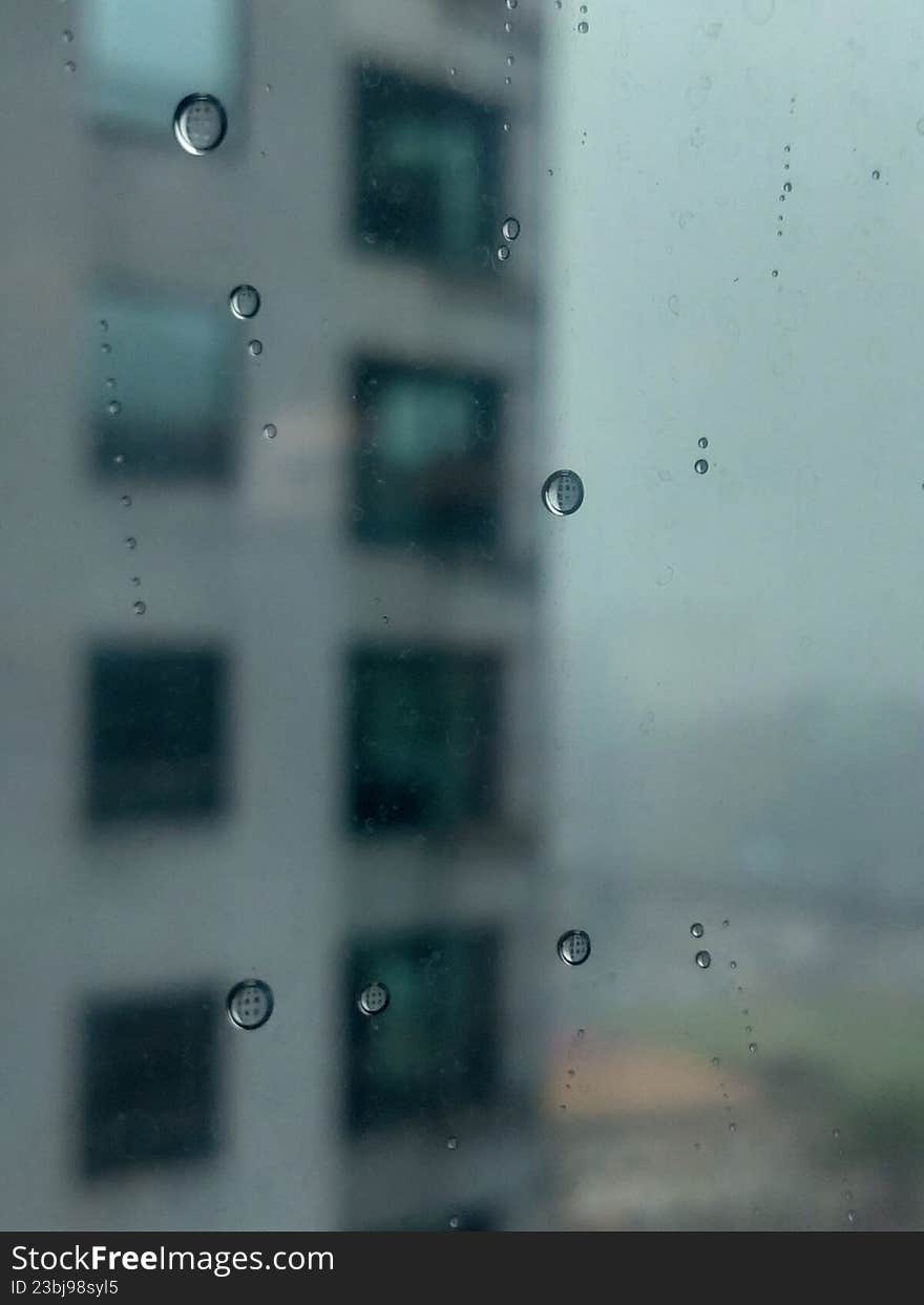 Raindrops sticking to the window pane of a building