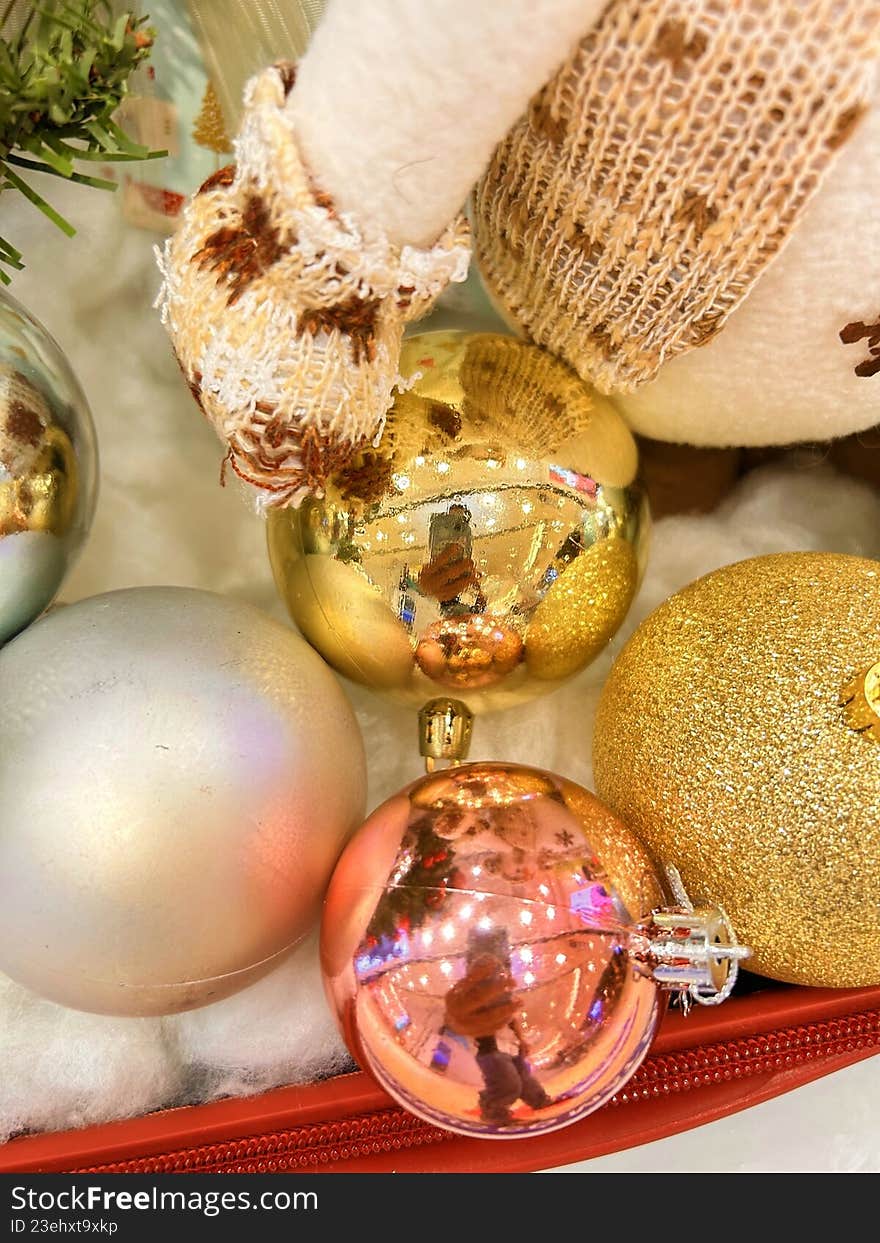 Golden and white Christmas baubles with cozy winter textures, creating an elegant and warm holiday decoration background.