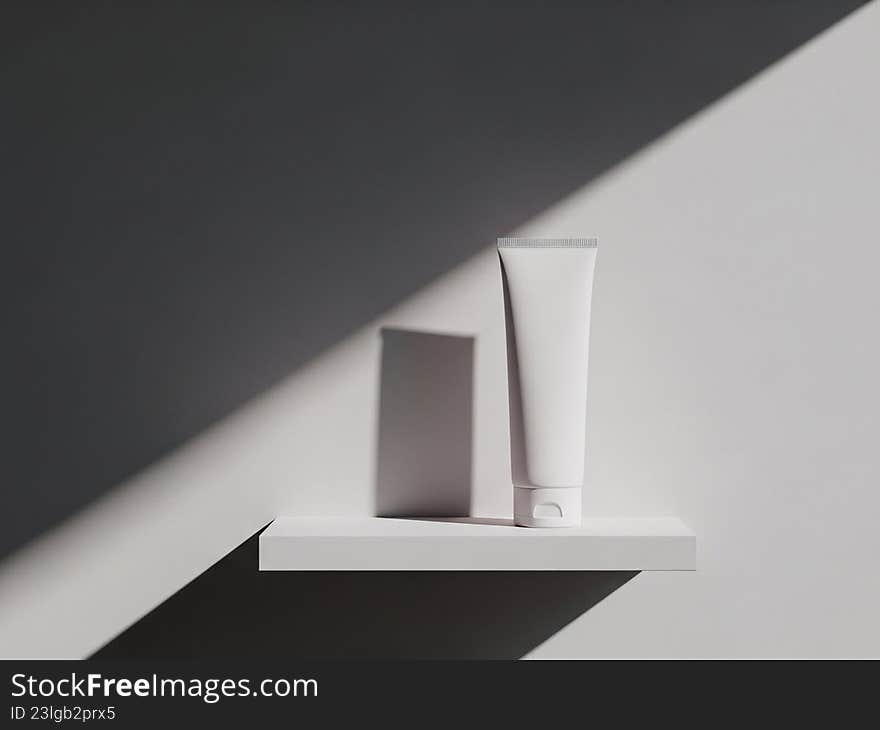 A minimalist image featuring a single tube of cosmetic cream placed on a white shelf. The tube is positioned upright, casting a subtle shadow. The background is a gradient of dark and light gray, creating a clean and modern aesthetic. A minimalist image featuring a single tube of cosmetic cream placed on a white shelf. The tube is positioned upright, casting a subtle shadow. The background is a gradient of dark and light gray, creating a clean and modern aesthetic