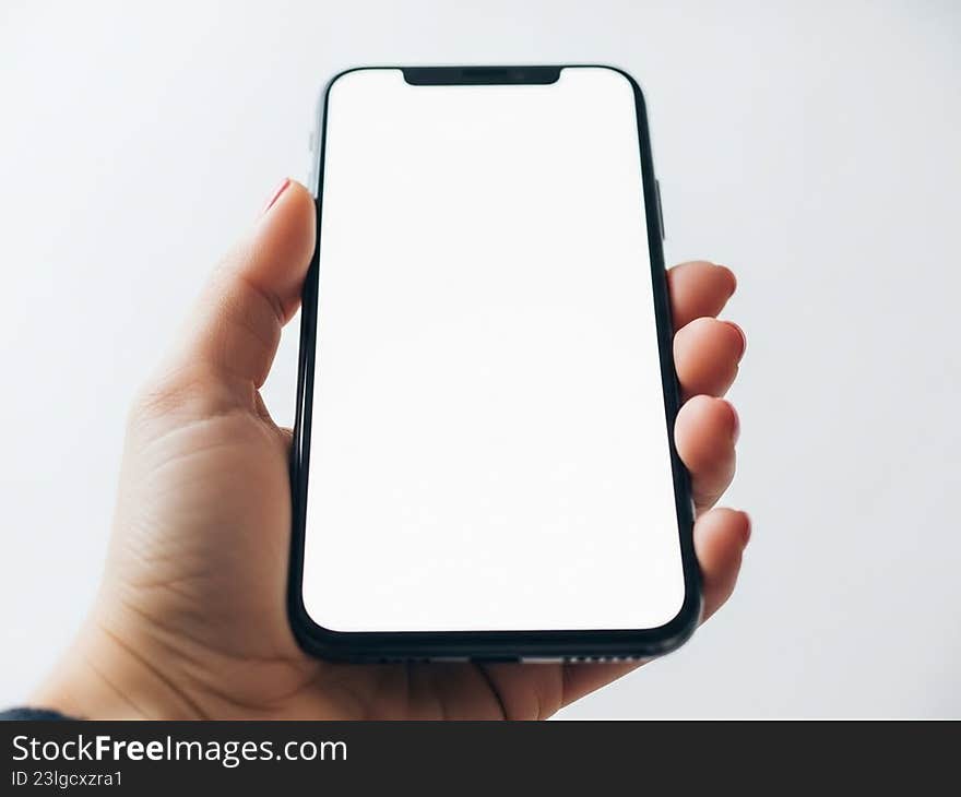 Hand holding black smartphone